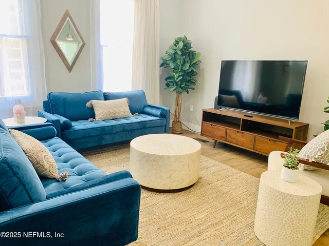 a living room with furniture and a flat screen tv