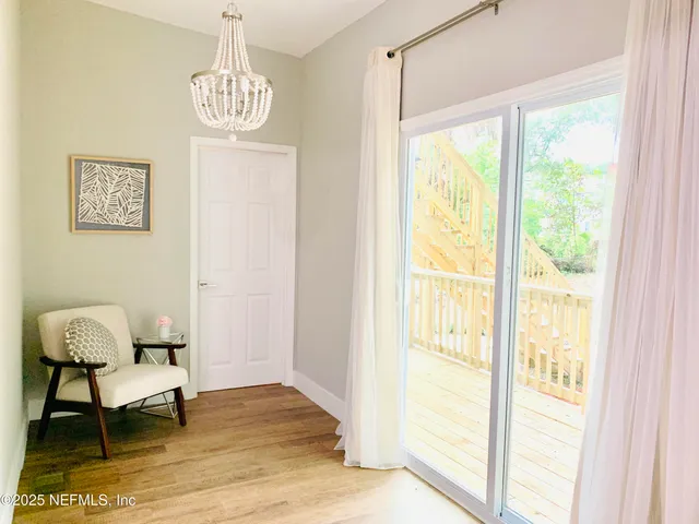 a view of a room with furniture and windows