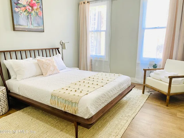 a bedroom with a bed and chair