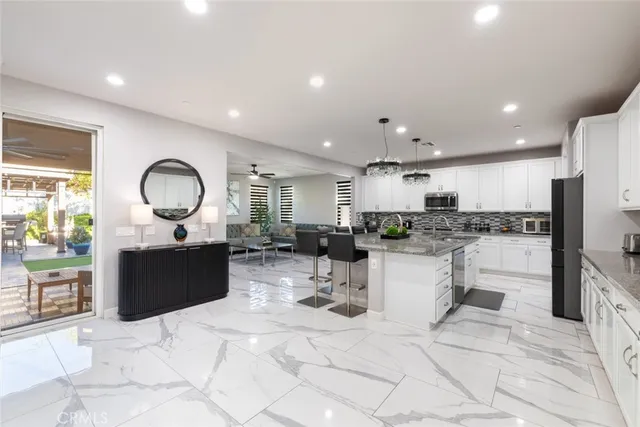 a large kitchen with lots of counter space and windows