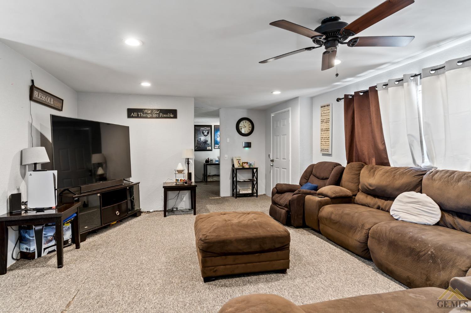 Undisclosed Address Bakersfield, CA 93306 - Photo 14 of 28 a living room with furniture and a flat screen tv