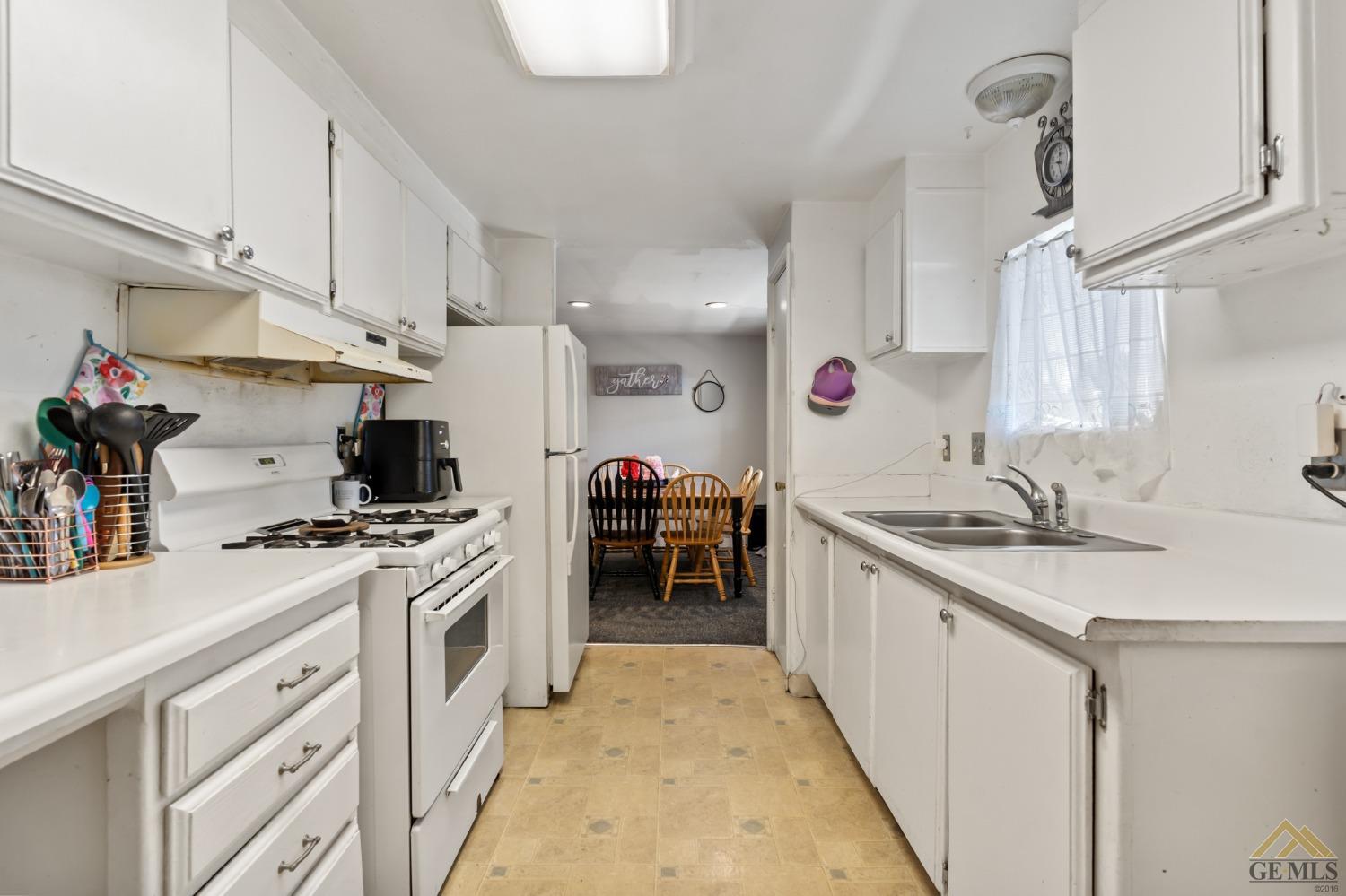 Undisclosed Address Bakersfield, CA 93306 - Photo 17 of 28 a kitchen with a sink a stove and cabinets