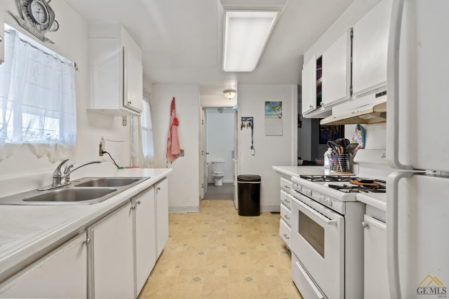 Undisclosed Address Bakersfield, CA 93306 - Photo 18 of 28 a kitchen with stainless steel appliances granite countertop a sink stove and refrigerator