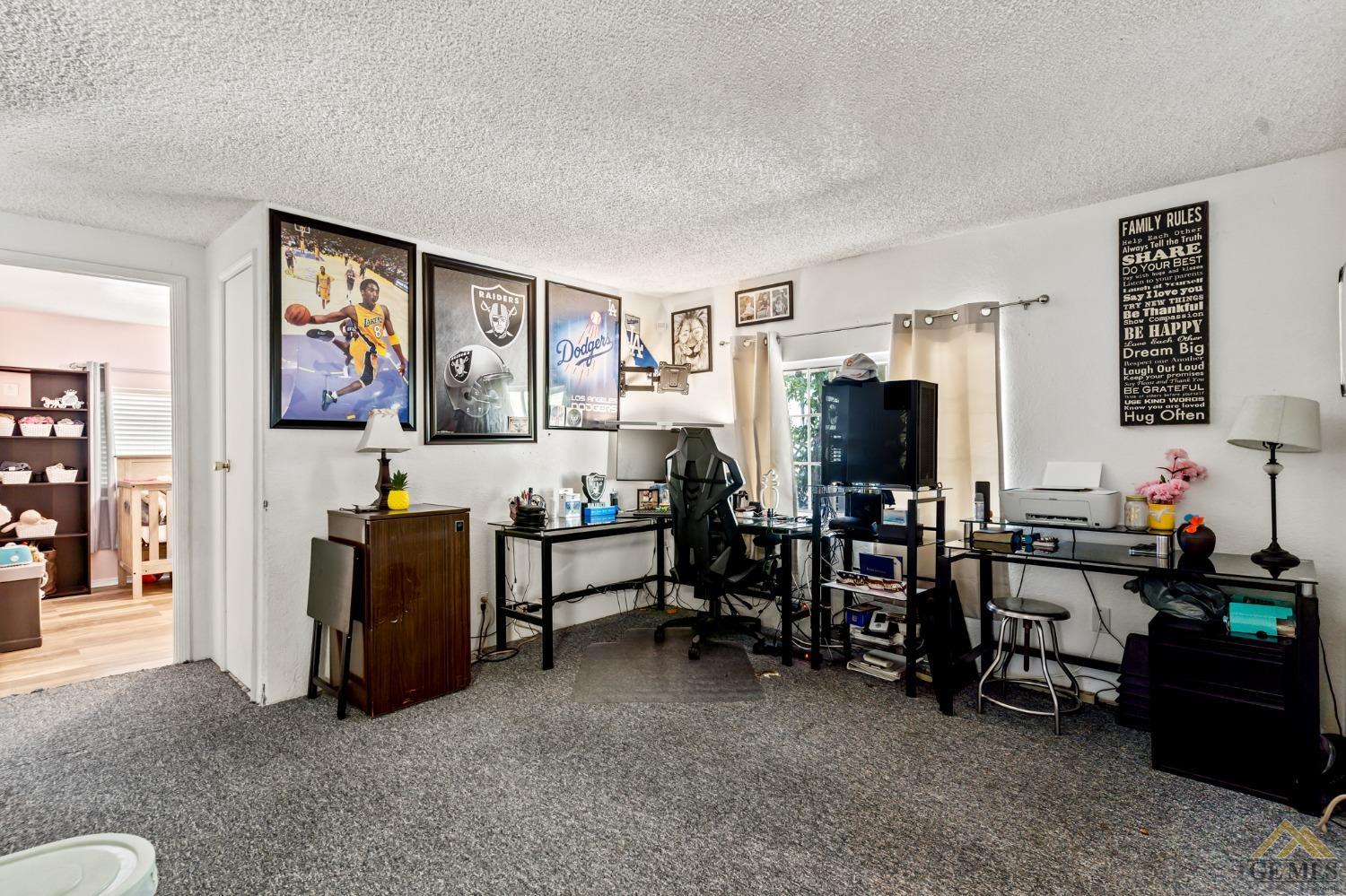 Undisclosed Address Bakersfield, CA 93306 - Photo 19 of 28 a living room with furniture and a flat screen tv