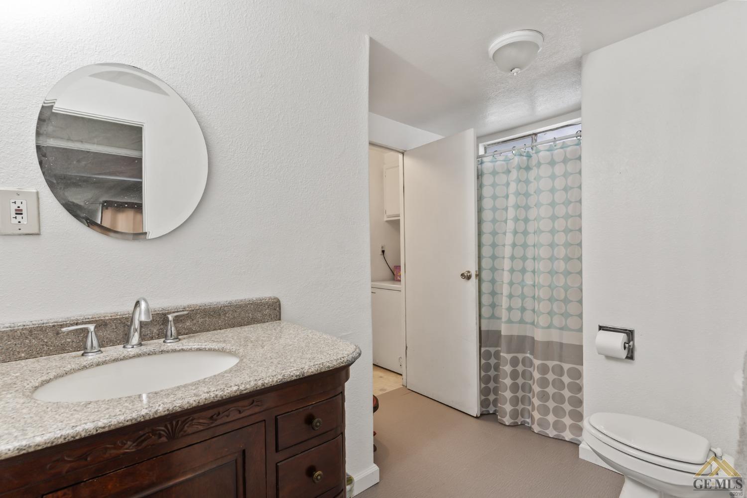 Undisclosed Address Bakersfield, CA 93306 - Photo 21 of 28 a bathroom with a granite countertop sink and a mirror