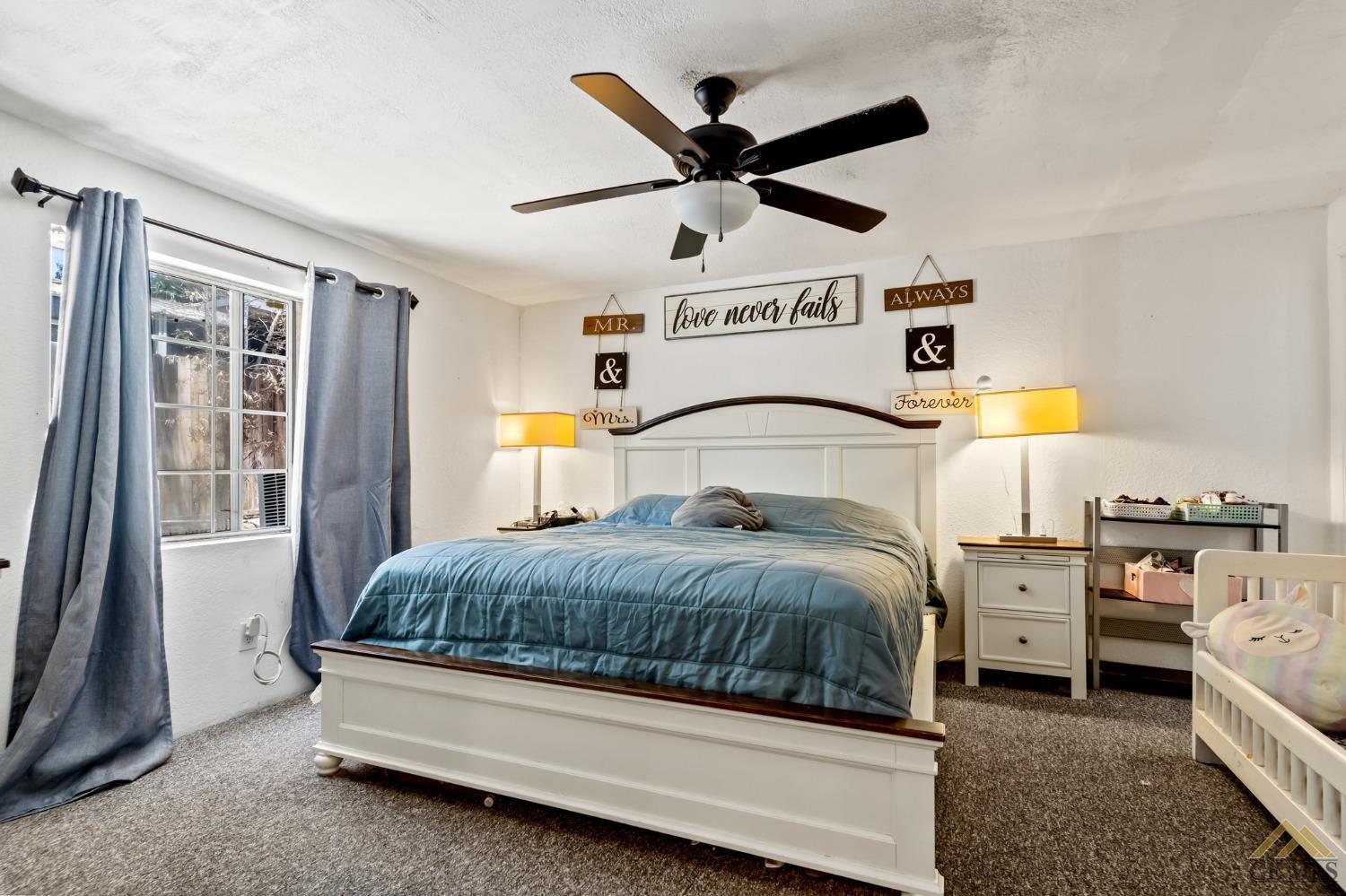 Undisclosed Address Bakersfield, CA 93306 - Photo 25 of 28 a bedroom with a bed and wooden floor