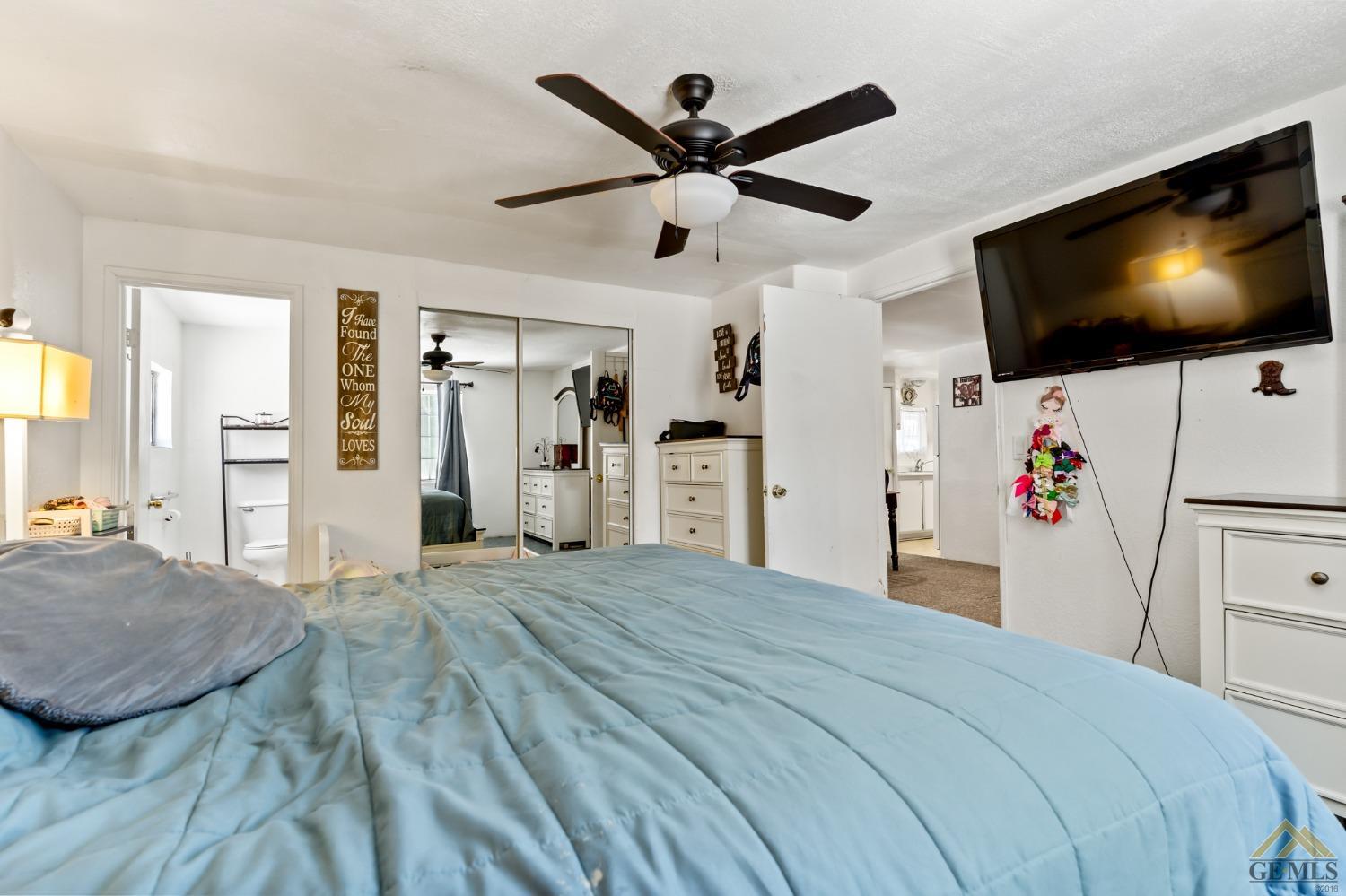 Undisclosed Address Bakersfield, CA 93306 - Photo 26 of 28 a bedroom with a bed and a flat screen tv