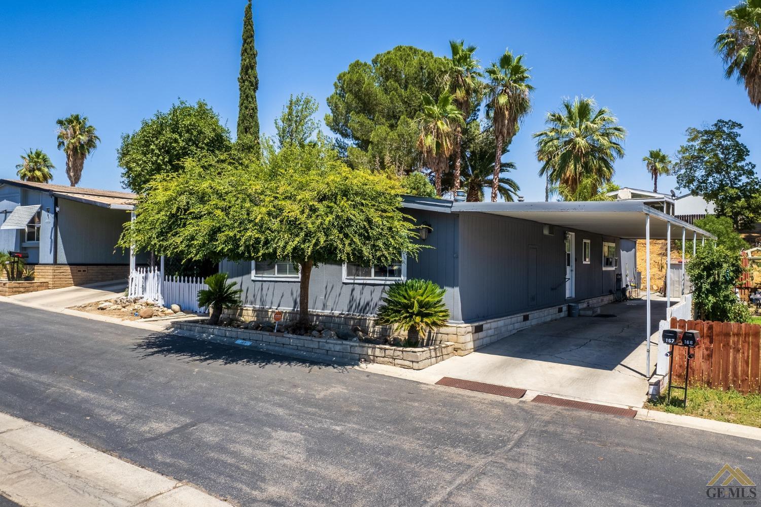 Undisclosed Address Bakersfield, CA 93306 - Photo 3 of 28 a front view of a house with a yard