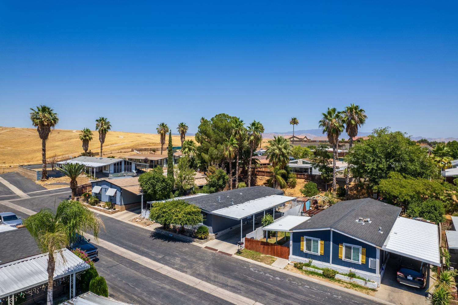 Undisclosed Address Bakersfield, CA 93306 - Photo 6 of 28 a aerial view of multiple houses with a yard