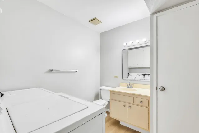 a utility room with a sink dryer and washer