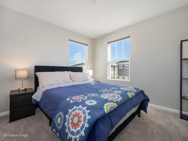 a bedroom with a bed and a lamp