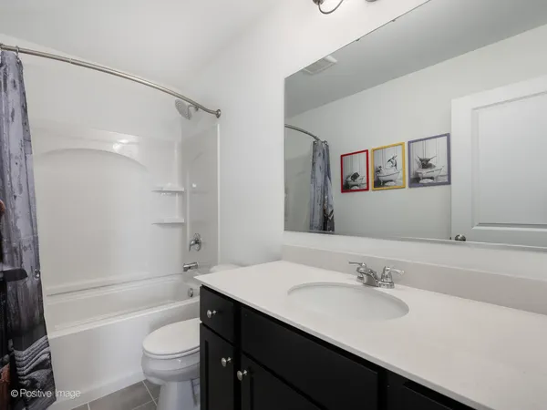 a bathroom with a sink toilet tub and shower