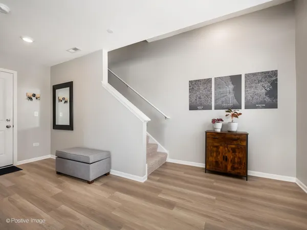 a living room with furniture and a hallway