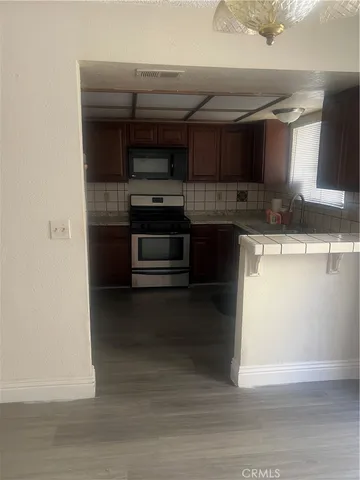 a kitchen with stainless steel appliances a stove and a sink