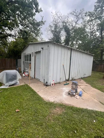 a backyard of a house with table and chairs