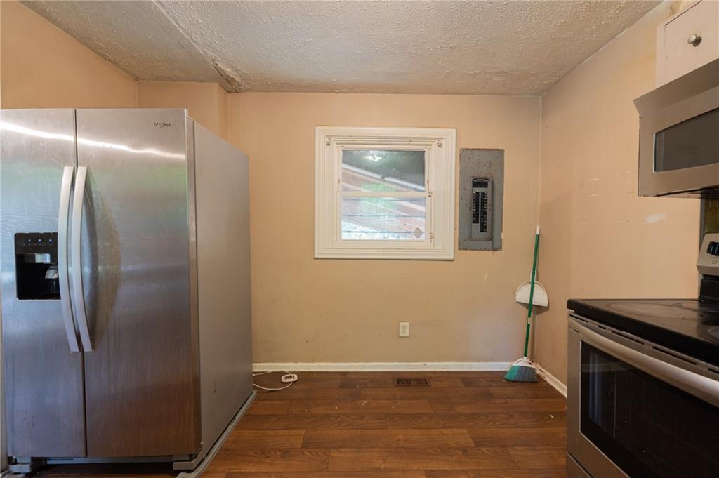 3838 Old Gordon Road Northwest Atlanta, GA 30336 - Photo 10 of 23 a view of a kitchen with wooden floor electronic appliances and cabinets