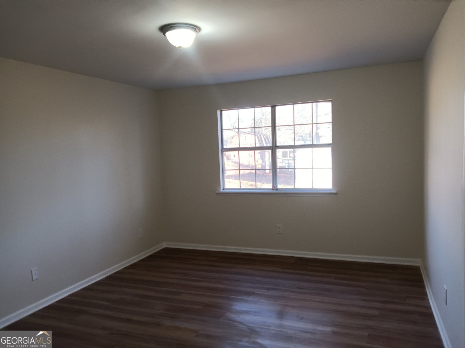 3668 Paddington Trail Rex, GA 30273 - Photo 15 of 21 an empty room with wooden floor and windows