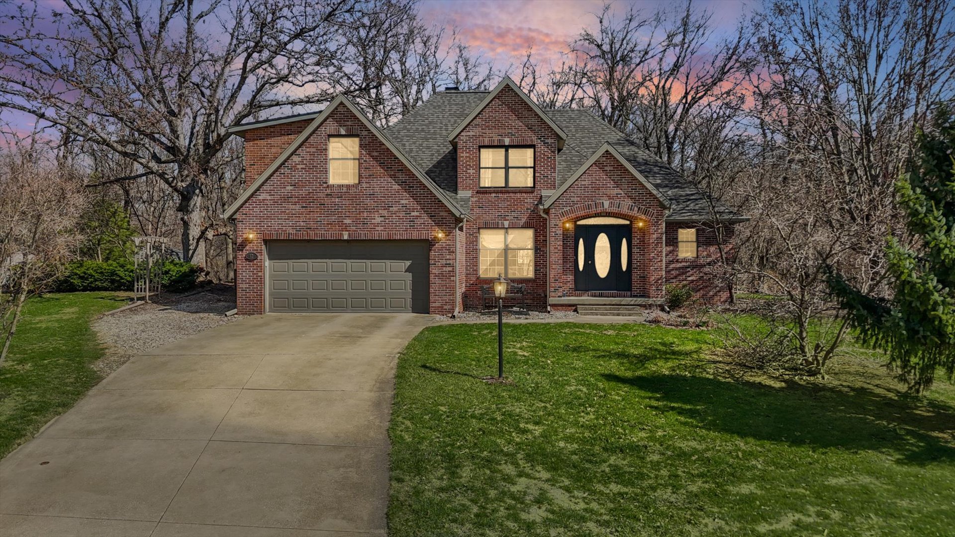 a front view of a house with a yard and garage