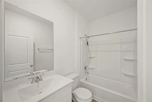 a bathroom with a bathtub shower sink vanity and toilet