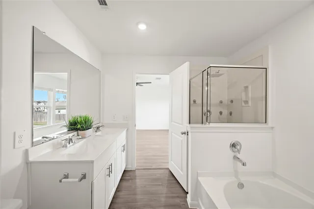 a bathroom with a bathtub a sink and mirror