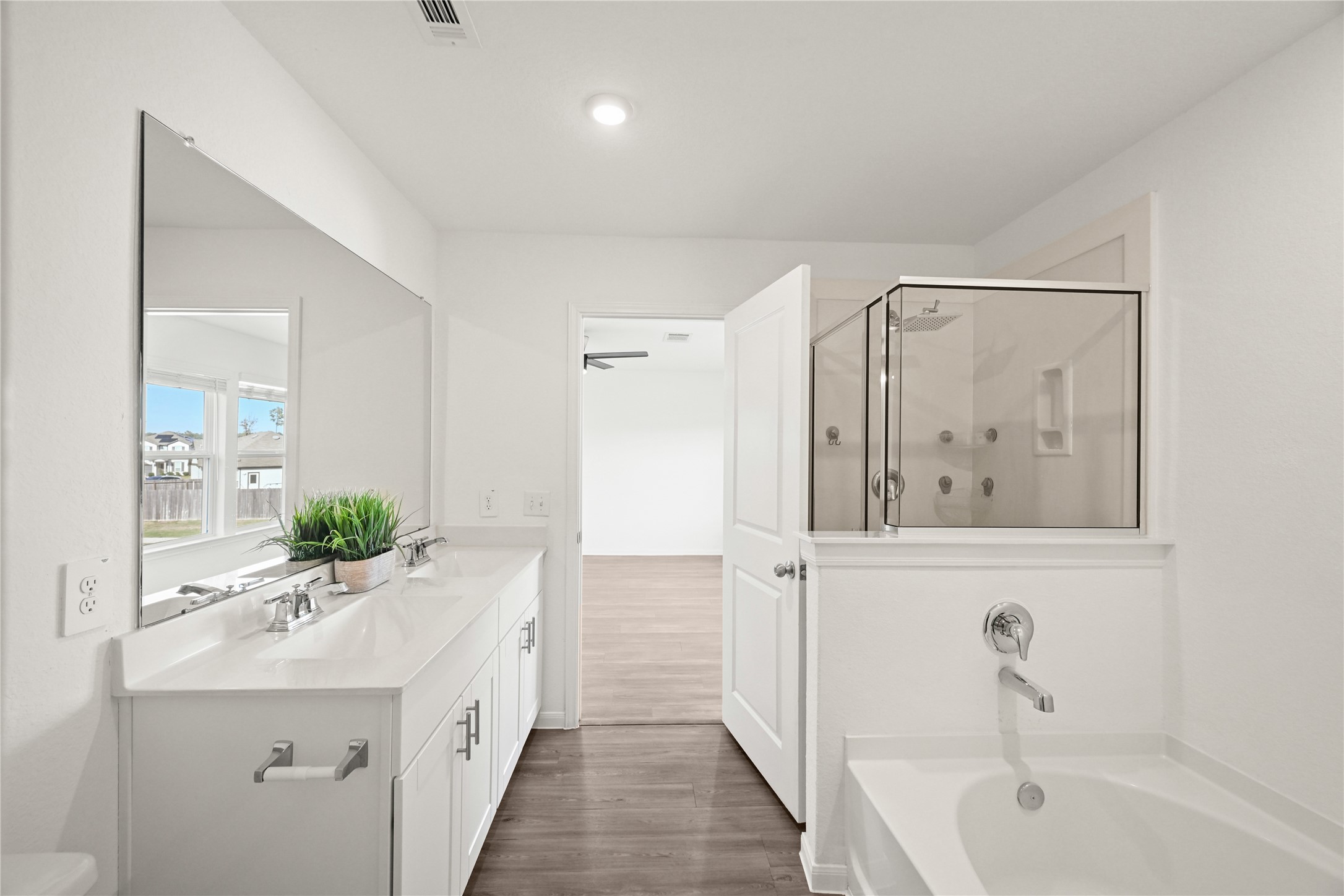 23442 Wrexham Street Spring, TX 77373 - Photo 14 of 33 a bathroom with a bathtub a sink and mirror