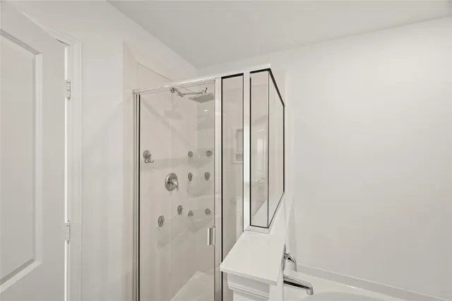 a bathroom with a shower and a sink