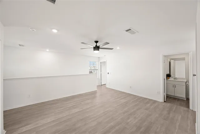 an empty room with a empty space and a ceiling fan