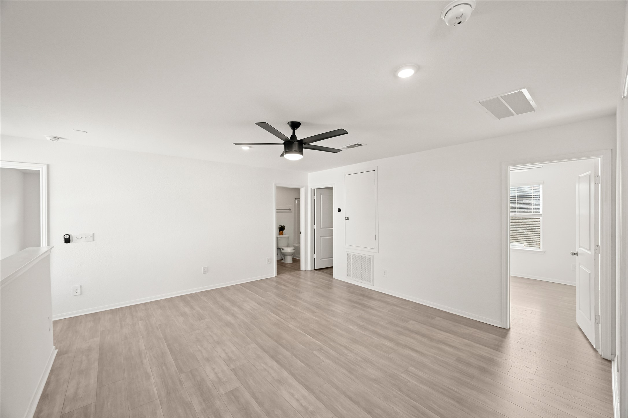 23442 Wrexham Street Spring, TX 77373 - Photo 21 of 33 an empty room with wooden floor a ceiling fan and windows