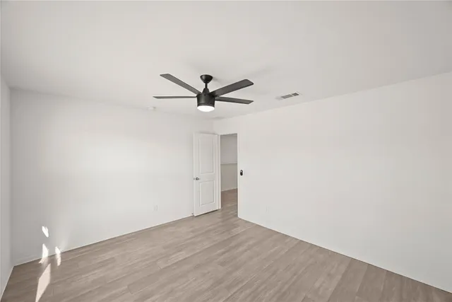 a view of a big room with wooden floor closet and windows