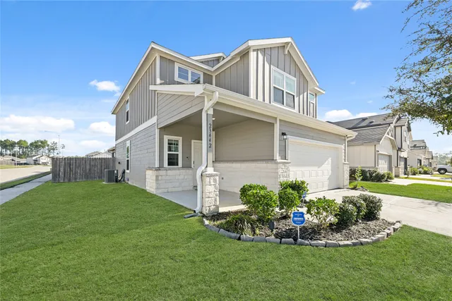a front view of a house with a garden and plants
