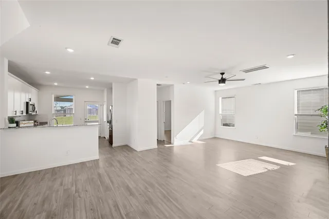 a view of a kitchen with wooden floor and a sink