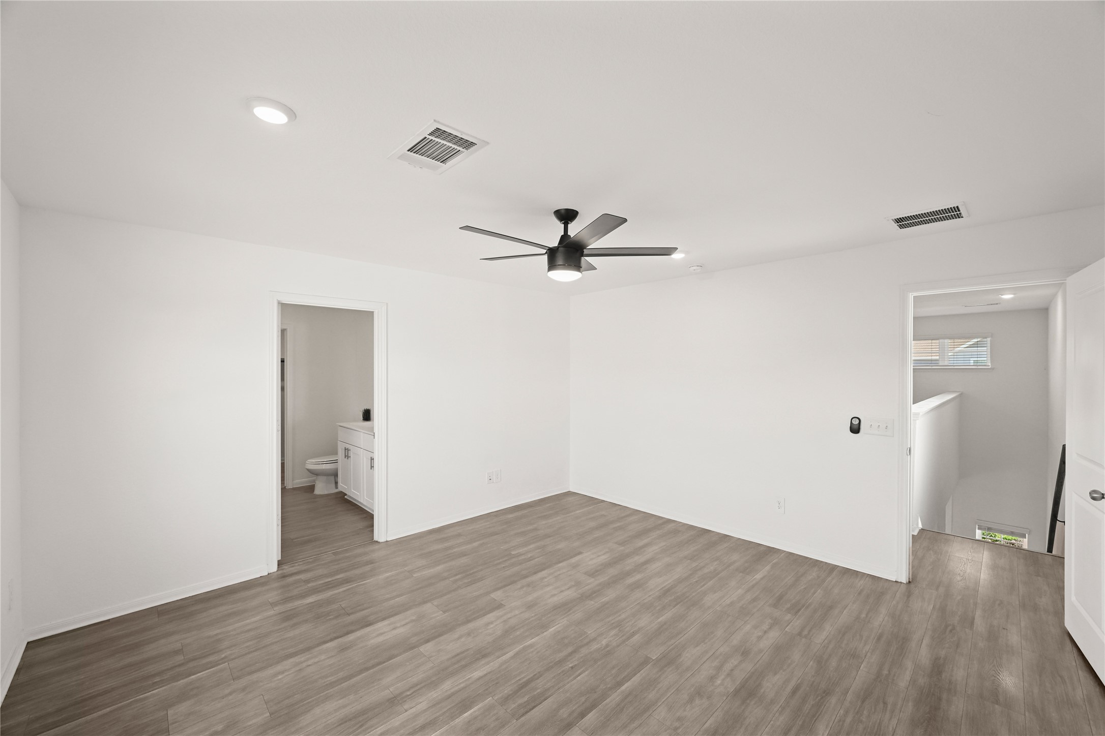 23442 Wrexham Street Spring, TX 77373 - Photo 10 of 33 an empty room with wooden floor and windows