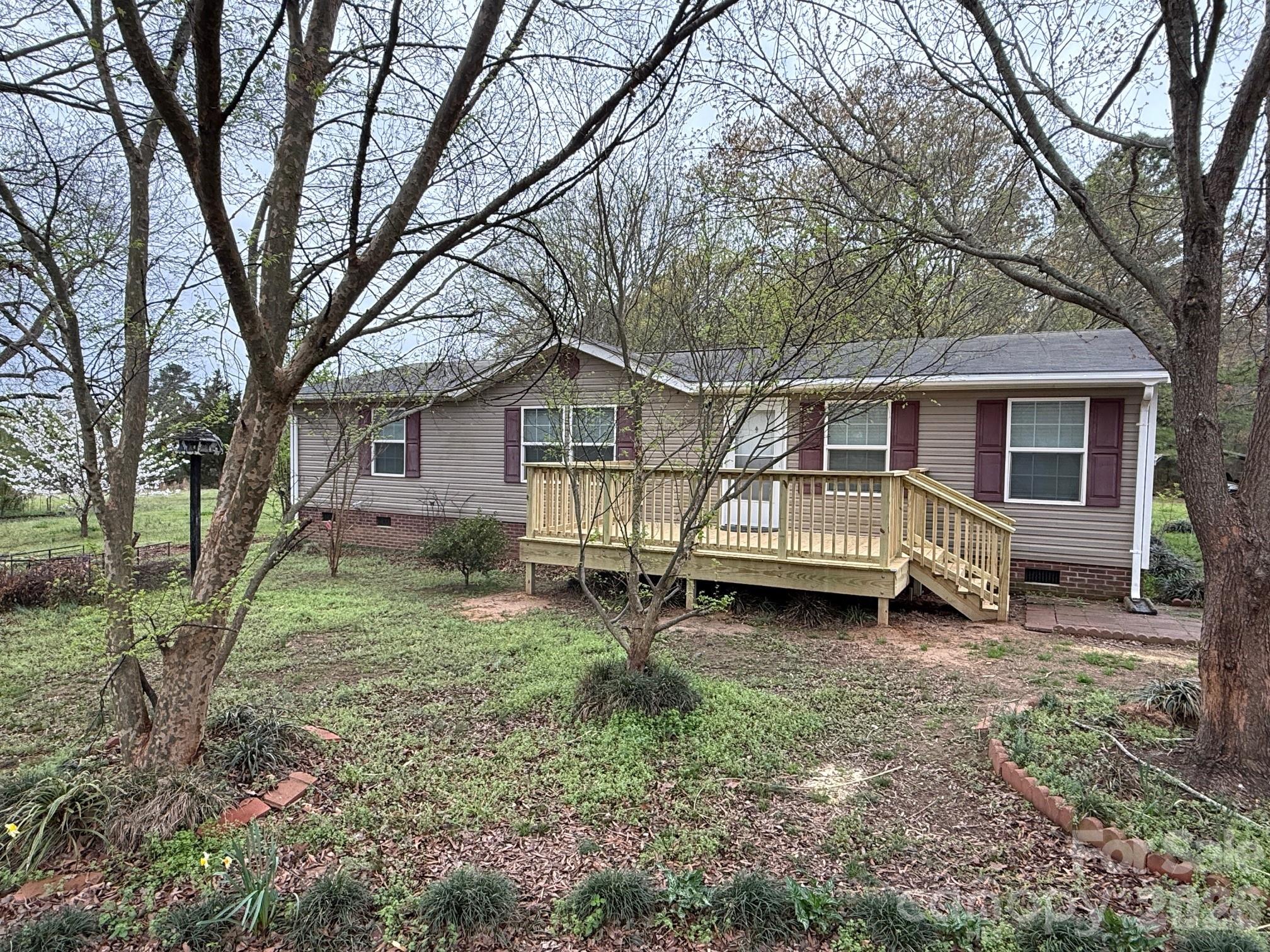247 Sam Tyson Road Wadesboro, NC 28170 - Photo 2 of 5 a view of a house with a yard