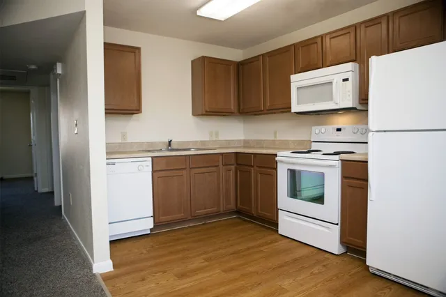 a kitchen with a sink cabinets and appliances