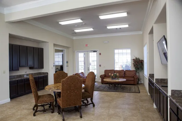 a living room with furniture and a dining table