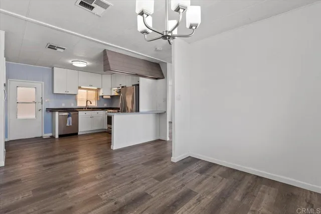 a view of a kitchen with a sink stainless steel appliances and cabinets
