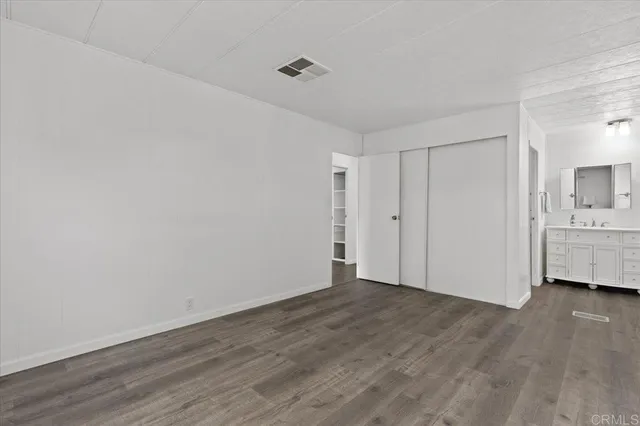 a view of a room with wooden floor and sink