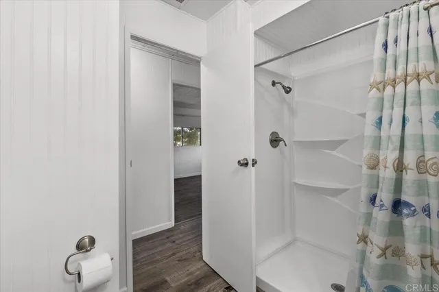 a bathroom with a glass shower door