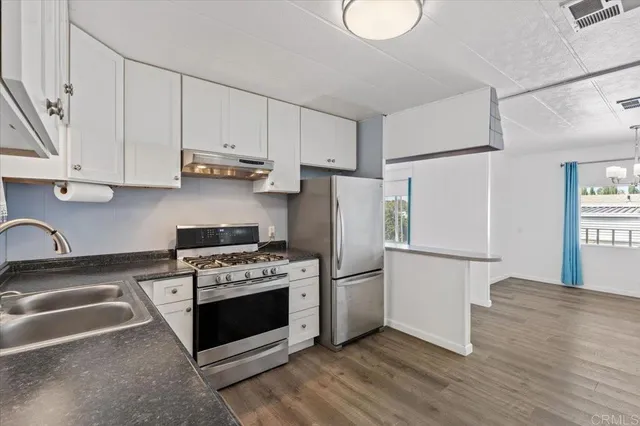 a kitchen with cabinets and steel stainless steel appliances