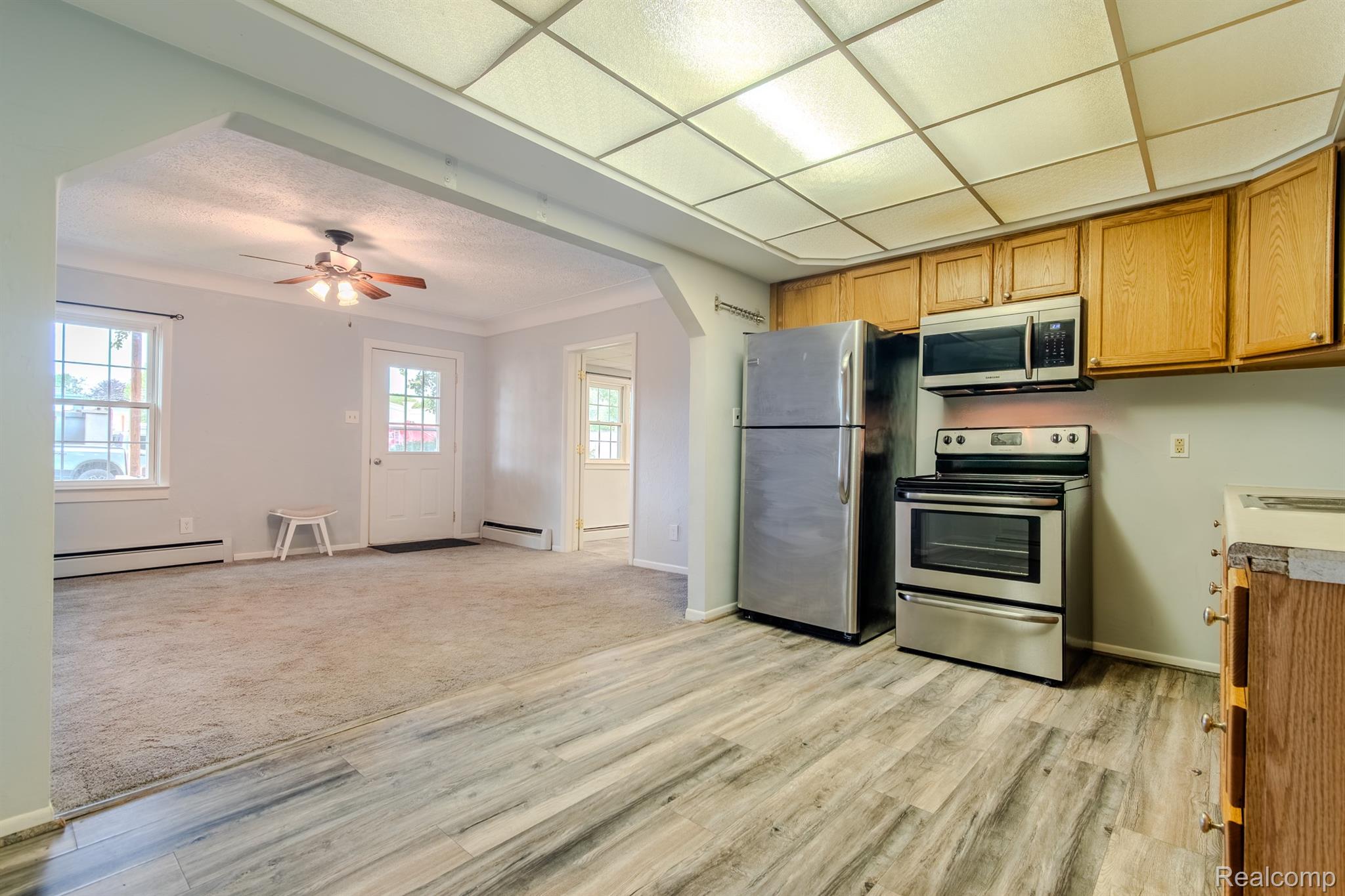 4644 South Rochester Road Royal Oak, MI 48073 - Photo 5 of 19 Galley kitchen featuring wood-finish cabinetry, stainless steel appliances, and wood-finish flooring