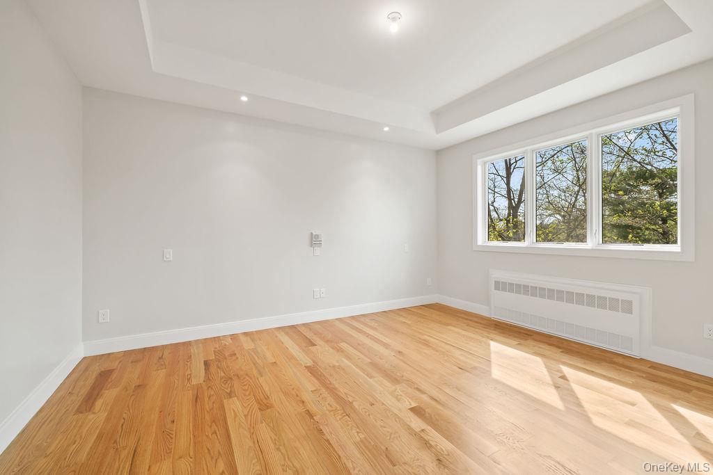 5 Mirror Lake Road, Unit 202 Spring Valley, NY 10977 - Photo 20 of 50 an empty room with wooden floor and windows