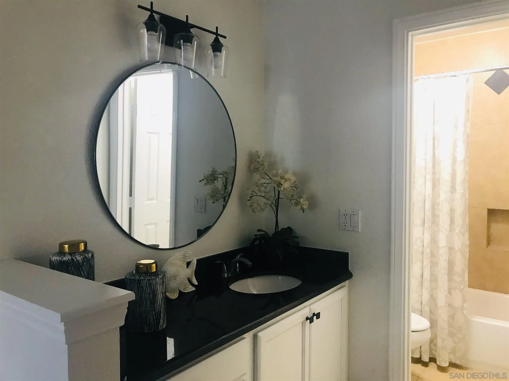 4860 Rolando Court, Unit 20 San Diego, CA 92115 - Photo 12 of 23 a bathroom with a sink and a mirror