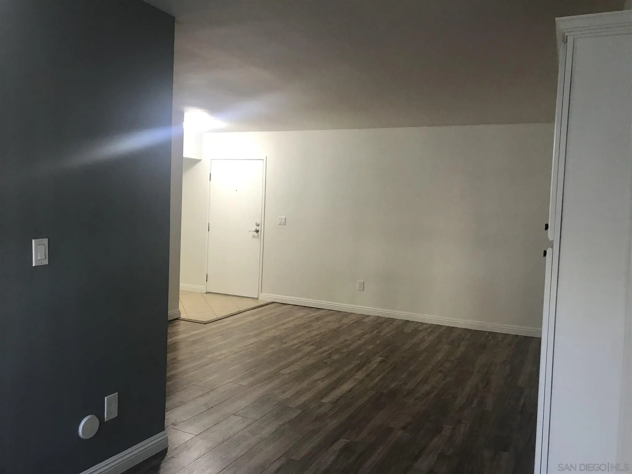 4860 Rolando Court, Unit 20 San Diego, CA 92115 - Photo 17 of 23 an empty room with wooden floor and windows