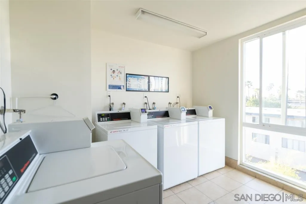 4860 Rolando Court, Unit 20 San Diego, CA 92115 - Photo 22 of 23 a living room with furniture a large window and a rug