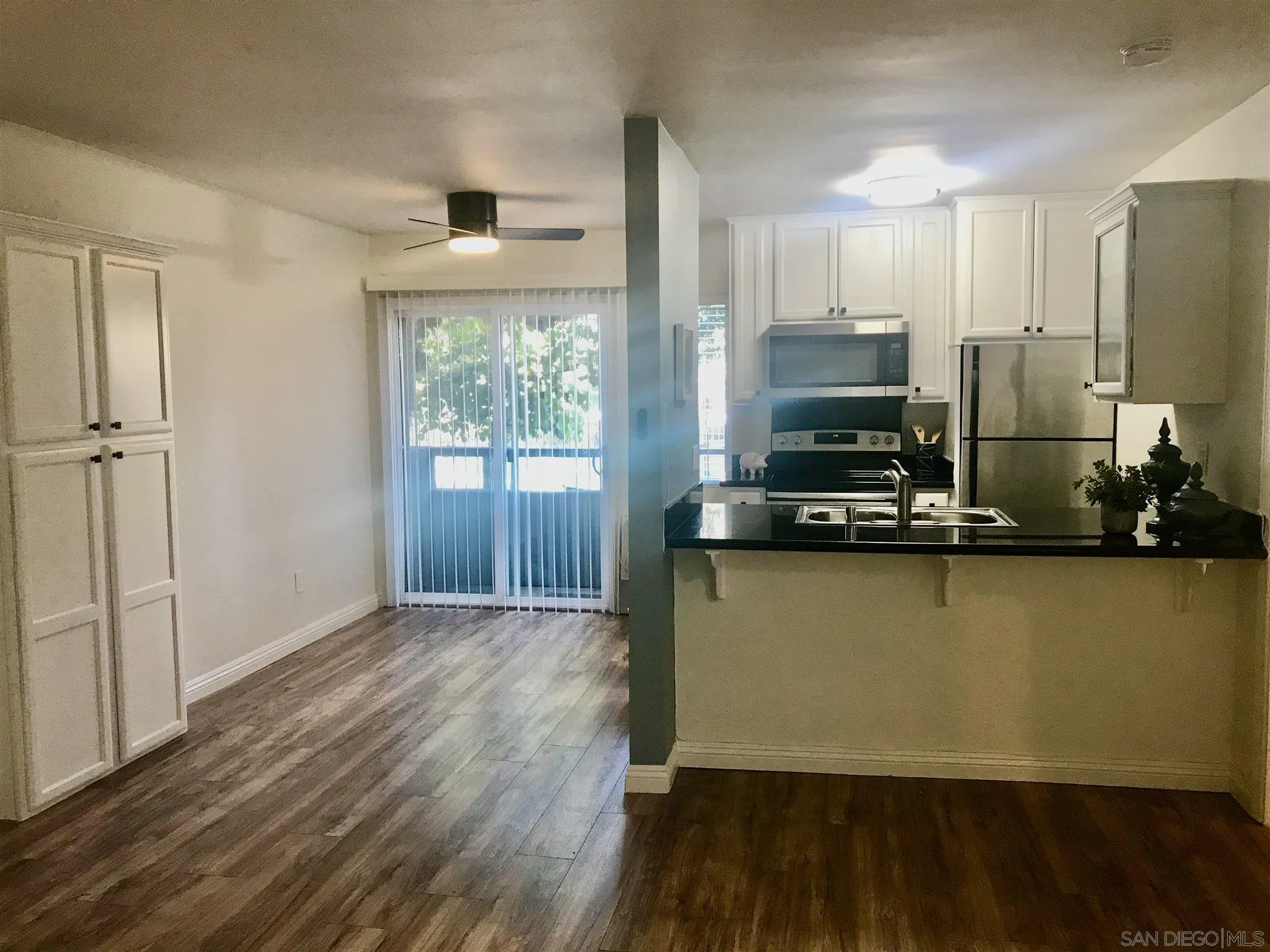 4860 Rolando Court, Unit 20 San Diego, CA 92115 - Photo 3 of 23 a view of a kitchen with wooden floor and a window