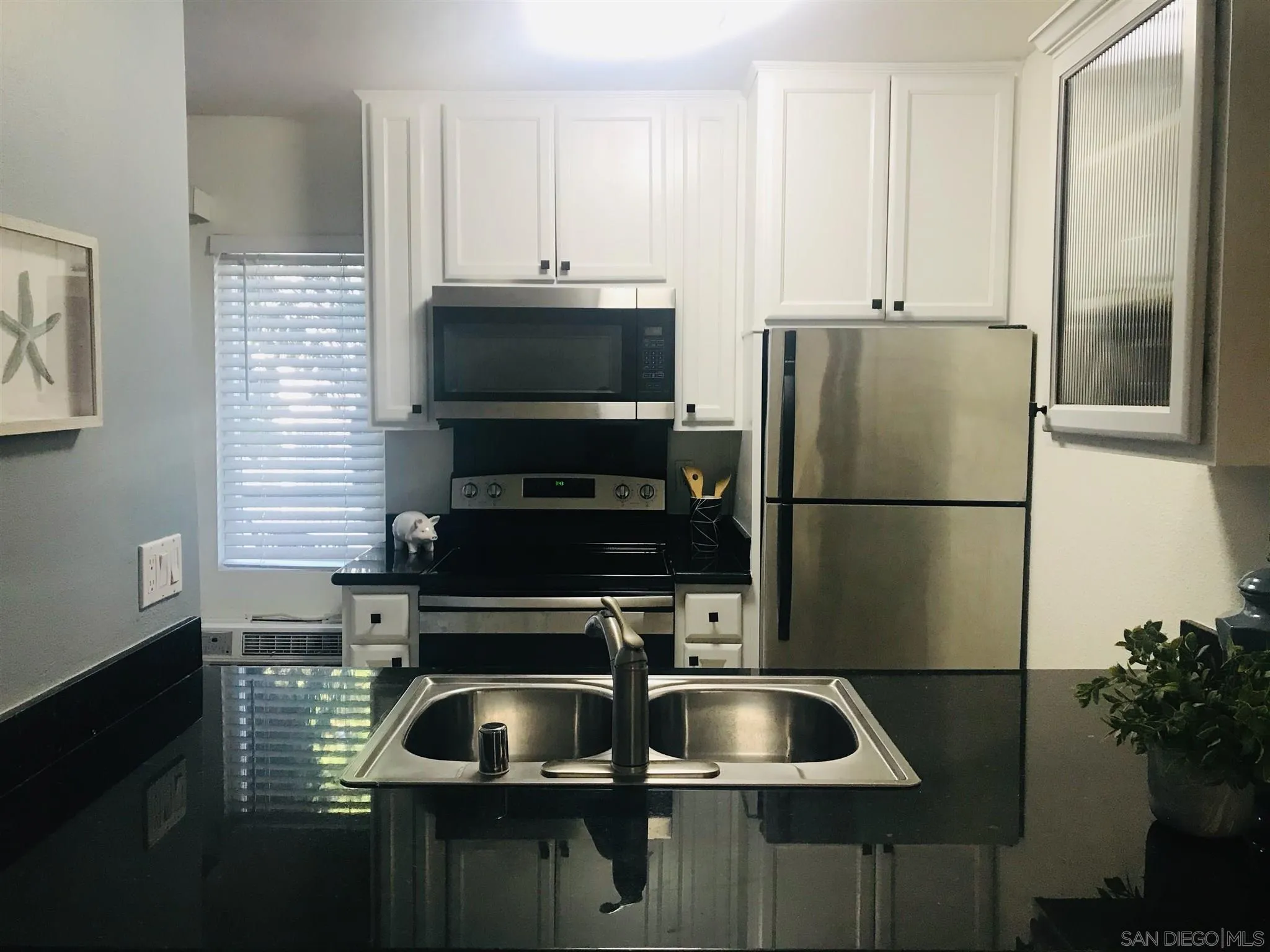 4860 Rolando Court, Unit 20 San Diego, CA 92115 - Photo 8 of 23 a kitchen with a sink and refrigerator