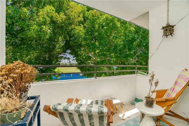 a view of balcony with two chairs and a table