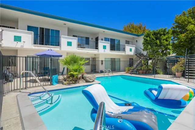 a view of a house with swimming pool and sitting area