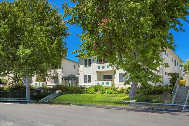 a white house with trees in front of it