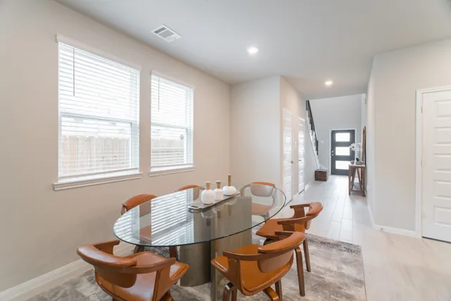 a dining room with furniture and window